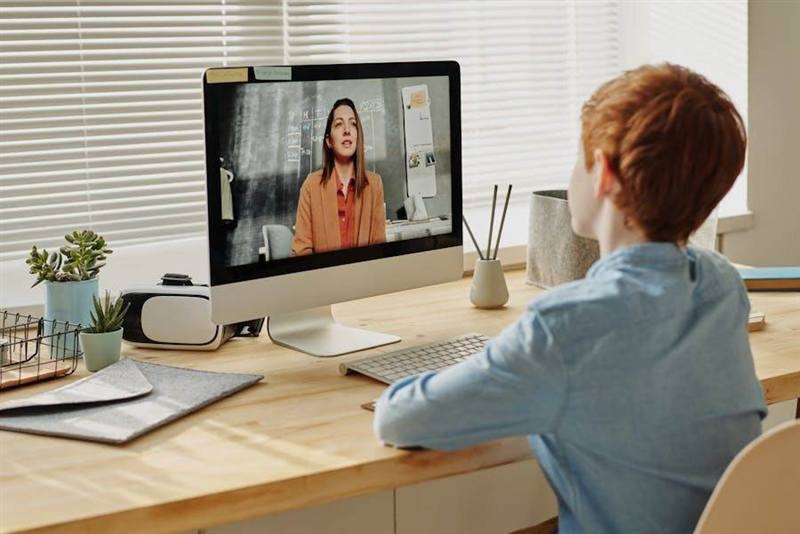 A student taking part in an online English lesson